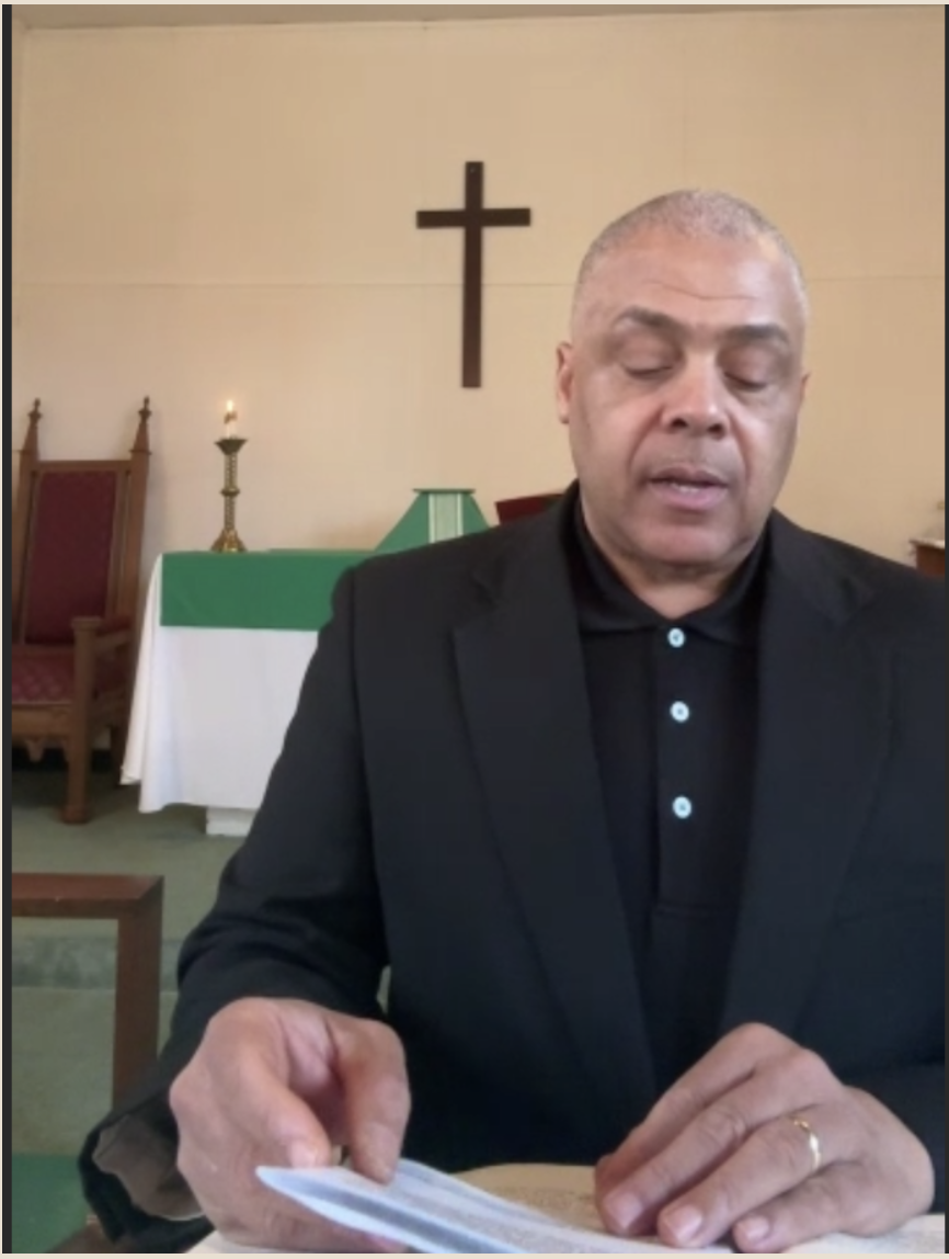 Lector proclaiming scripture at the lectern